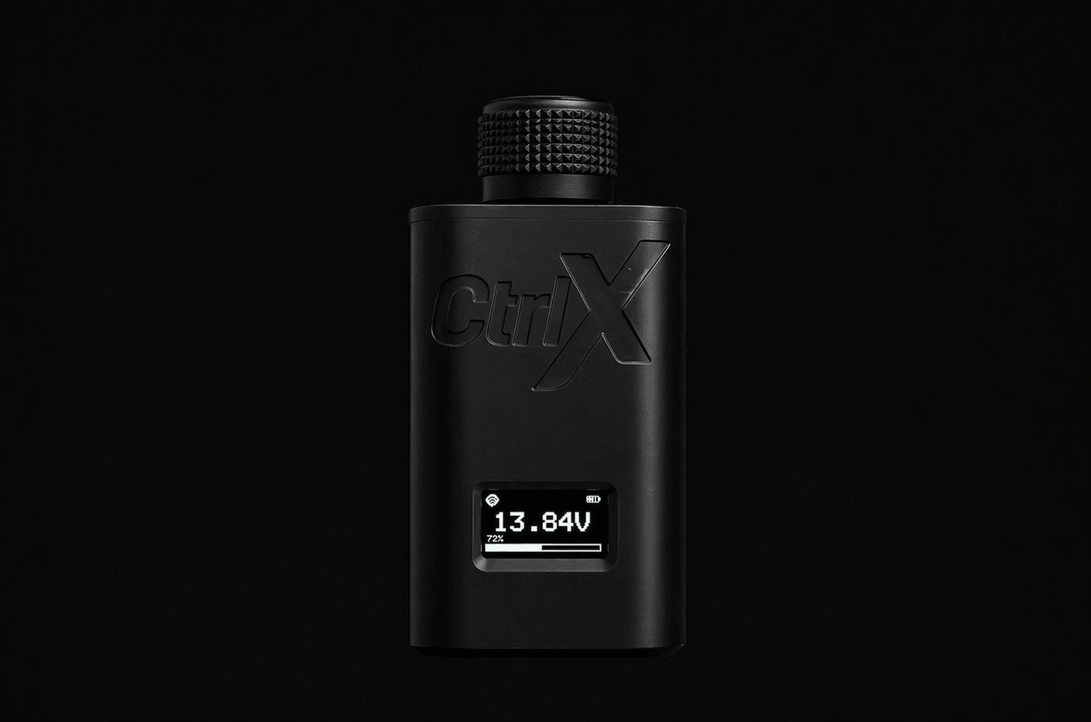 Black CtrlX wireless bass knob controller standing upright against a black background showing a 13.84V digital display screen